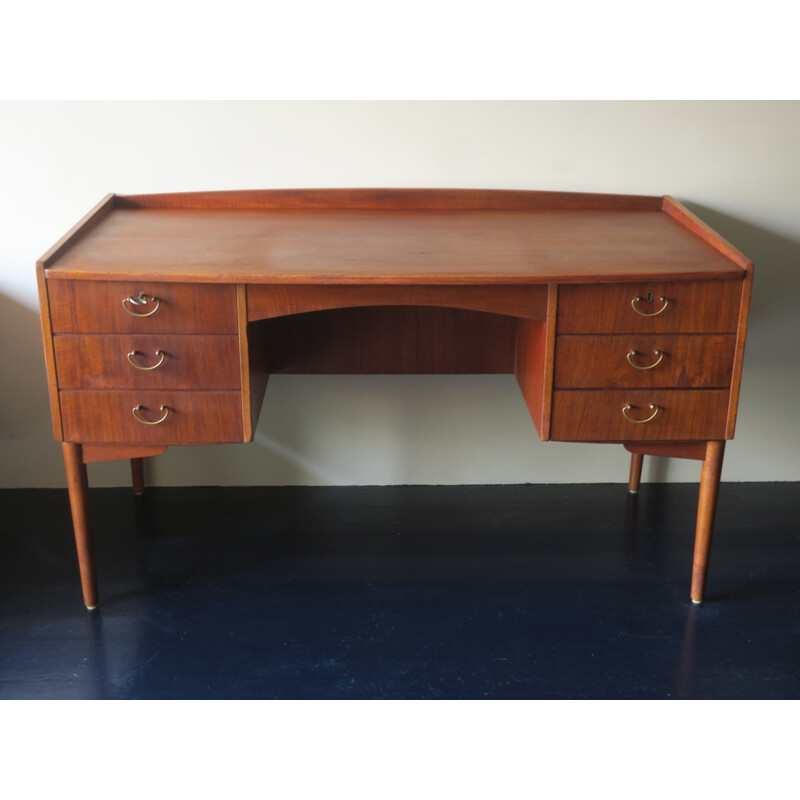 Vintage teak desk with curved shape raised edge and storage space Danish 1960s