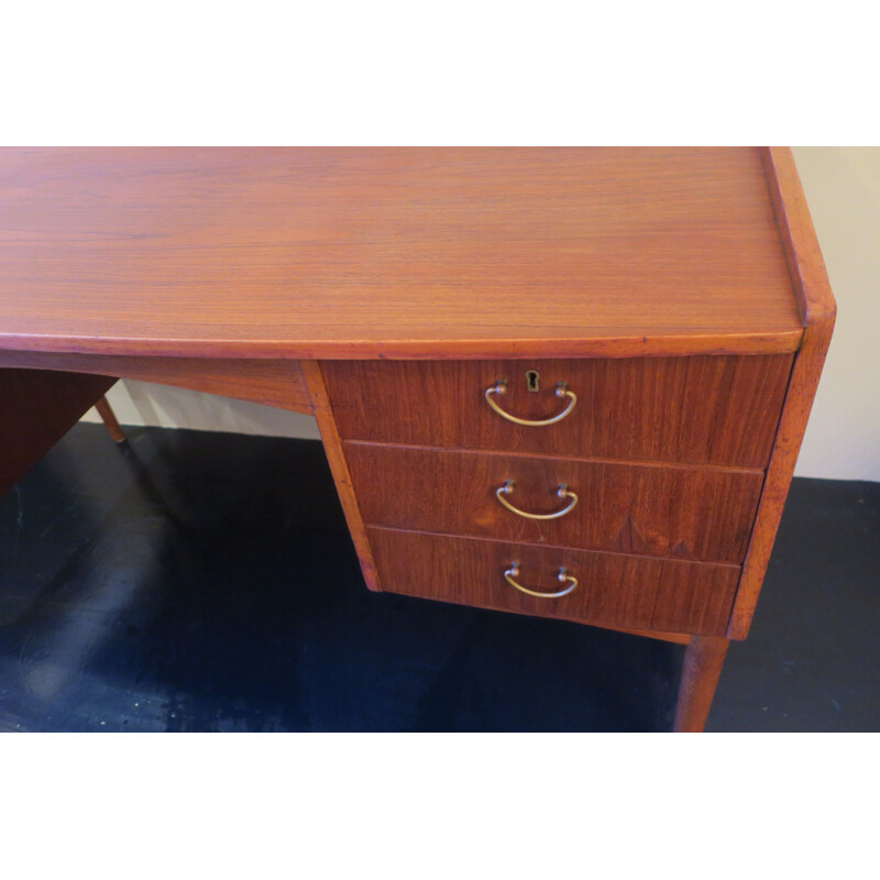 Vintage teak desk with curved shape raised edge and storage space Danish 1960s