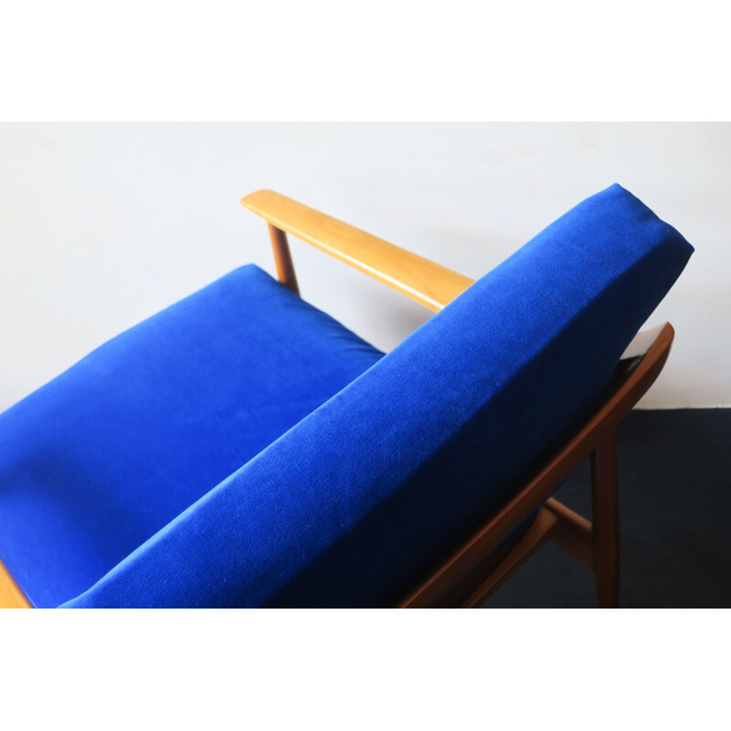 Vintage blue velvet lounge chair with curved back and sprung cushions 1960s