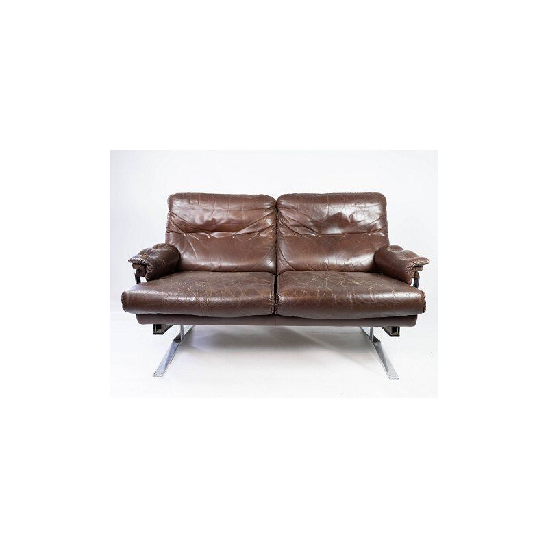 Vintage 2 seater sofa upholstered in brown leather and metal frame by Arne Norell 1970s
