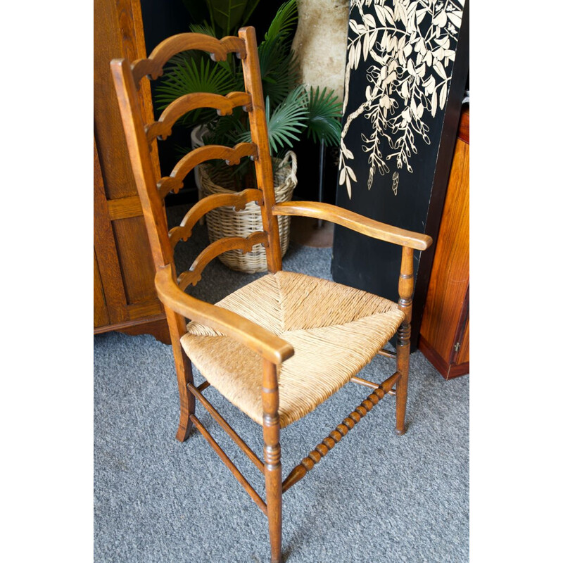 Vintage solid oak chair with ladder back and rush seat, England 1920