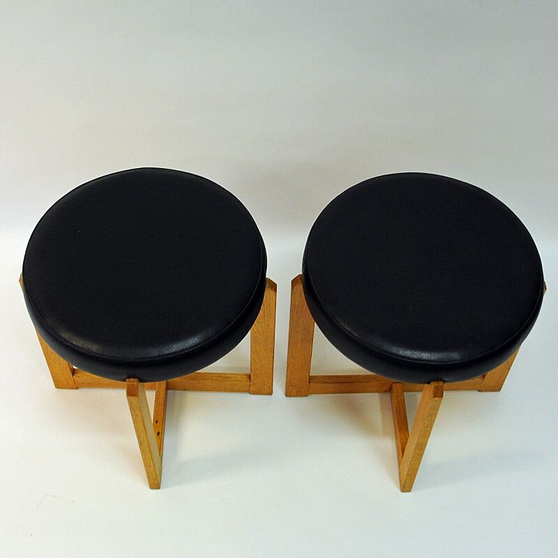Pair of vintage oakwood and black leatherette stools, Sweden 1960