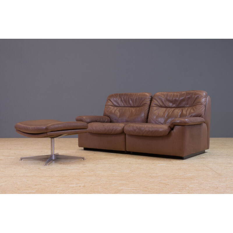 Set of vintage brown leather sofa and ottoman by De Sede