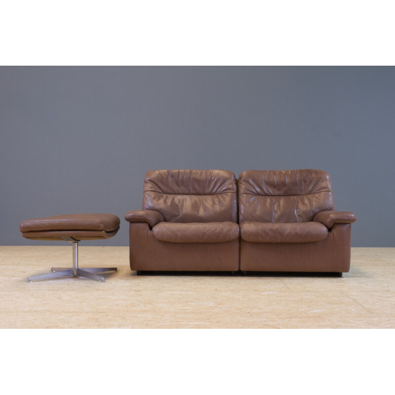 Set of vintage brown leather sofa and ottoman by De Sede