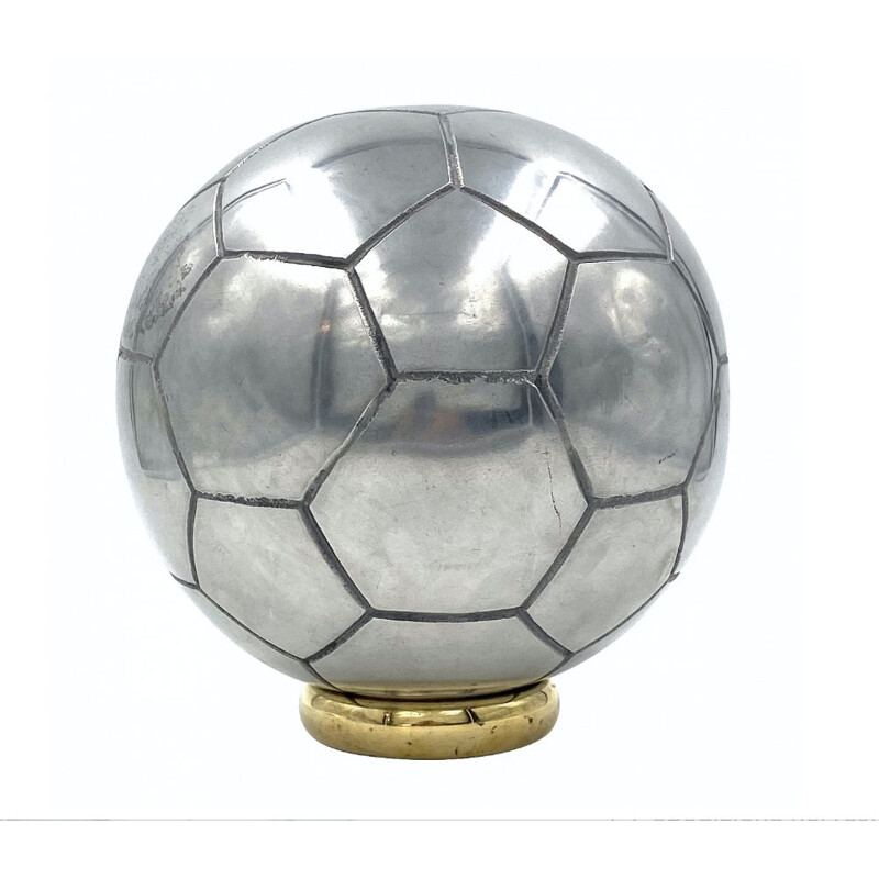 Vintage sculpture of a football in polished aluminium