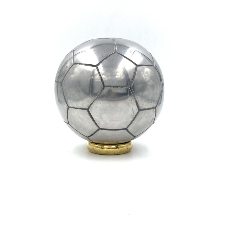 Vintage sculpture of a football in polished aluminium