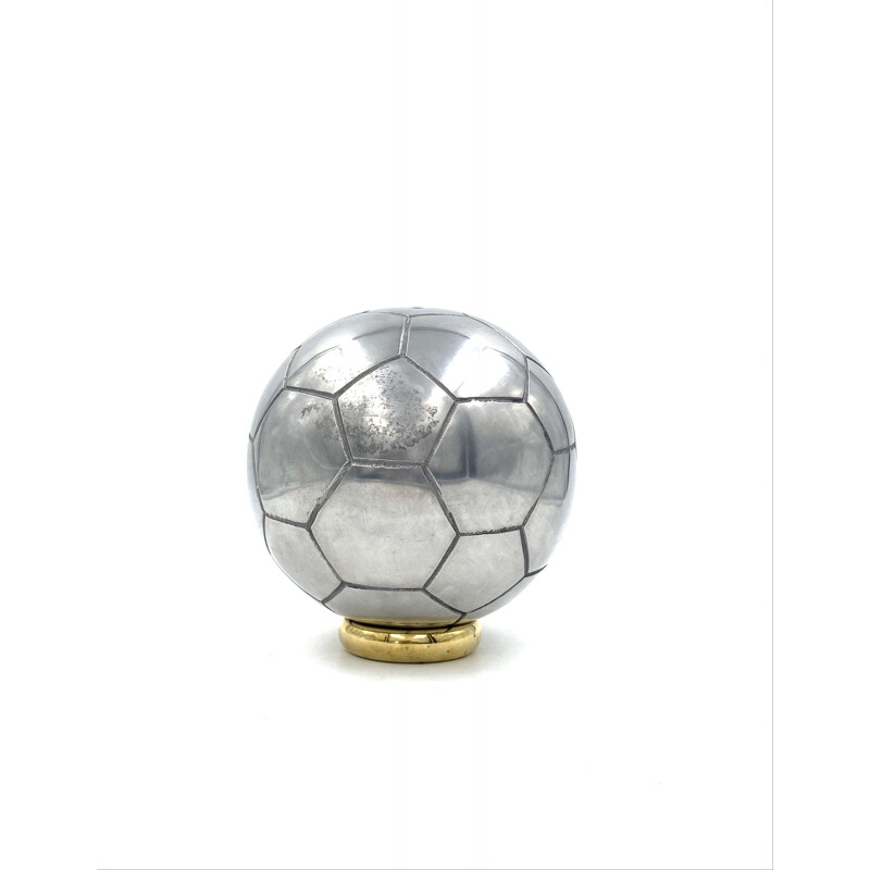 Vintage sculpture of a football in polished aluminium