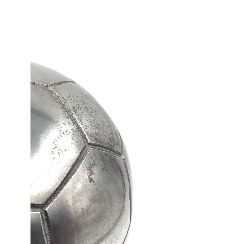 Vintage sculpture of a football in polished aluminium
