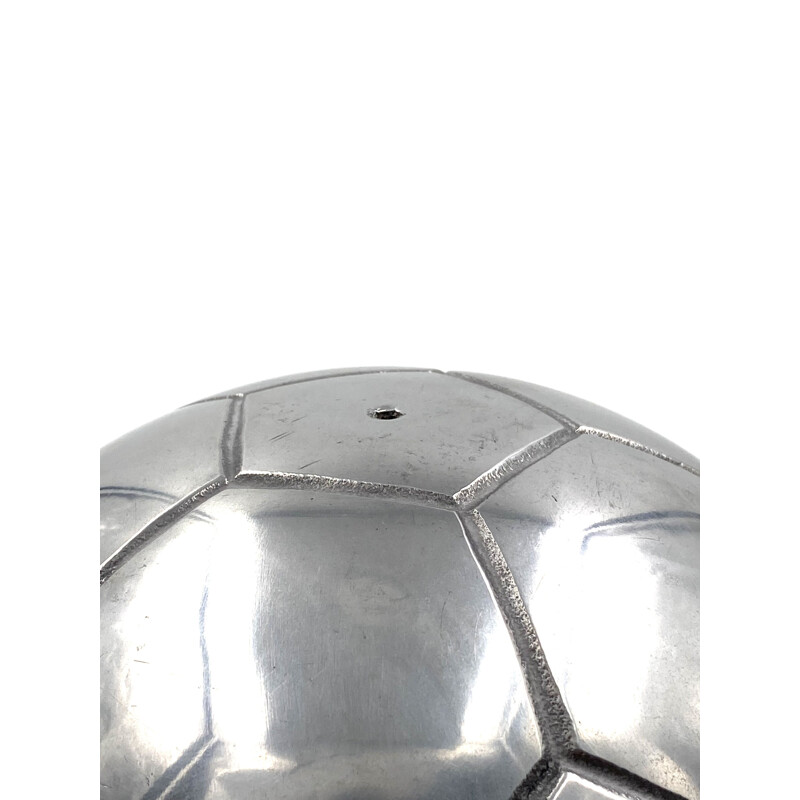 Vintage sculpture of a football in polished aluminium