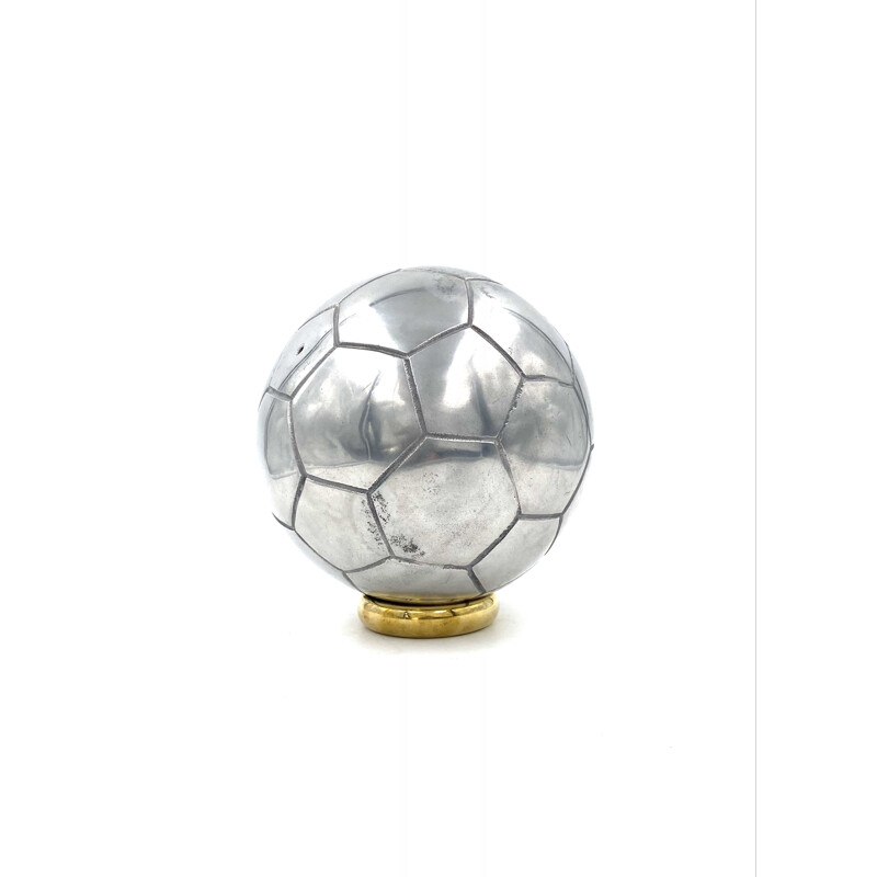 Vintage sculpture of a football in polished aluminium