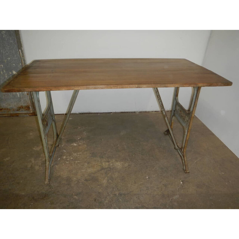 Vintage beechwood table on on Necchi cast iron bases