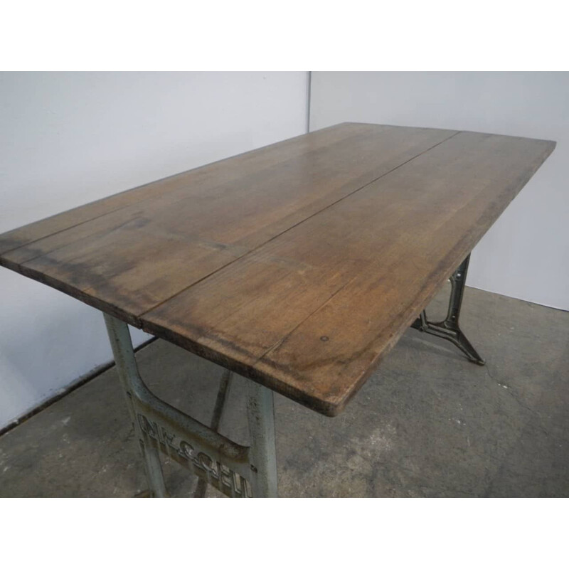 Vintage beechwood table on on Necchi cast iron bases