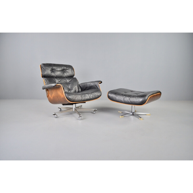 Vintage rosewood and black leather lounge chair with ottoman by Martin Stoll