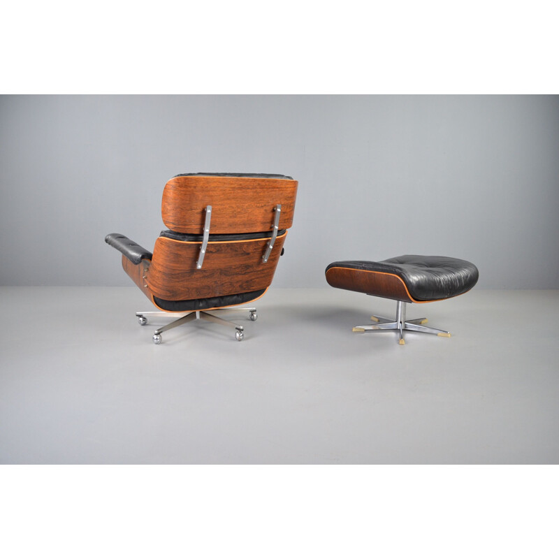Vintage rosewood and black leather lounge chair with ottoman by Martin Stoll