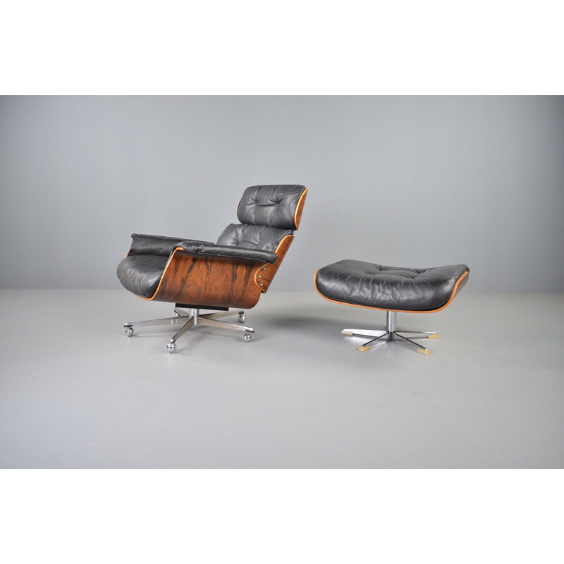 Vintage rosewood and black leather lounge chair with ottoman by Martin Stoll