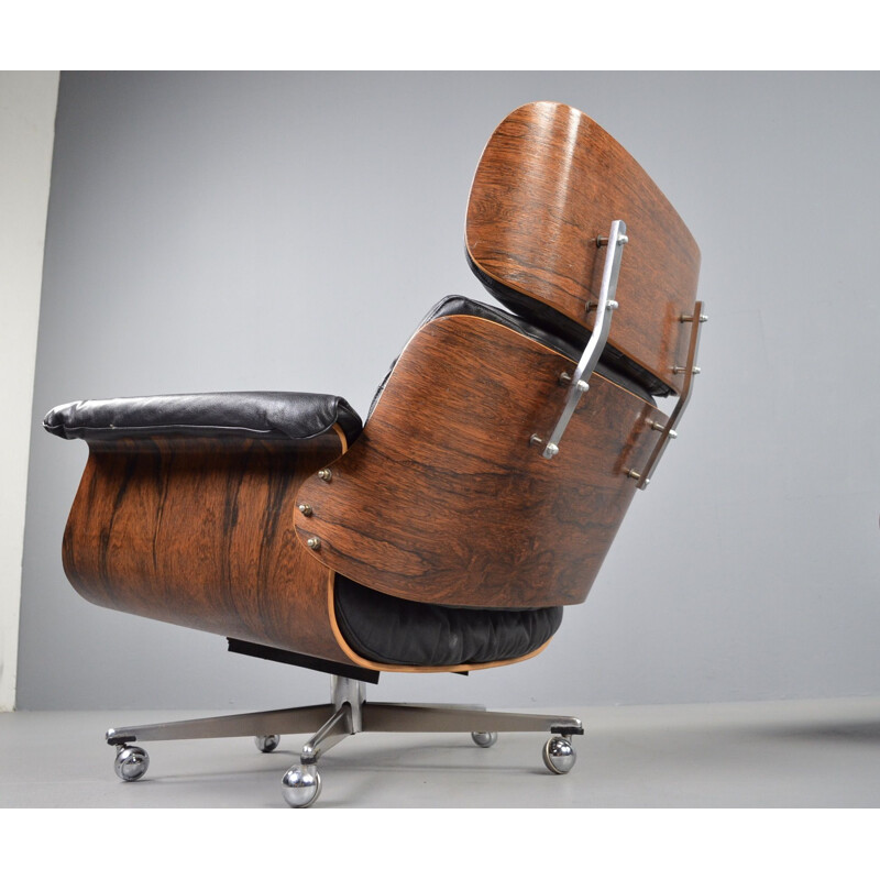 Vintage rosewood and black leather lounge chair with ottoman by Martin Stoll