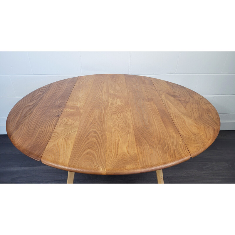 Vintage round elmwood and beechwood drop leaf dining table by Ercol, 1960s
