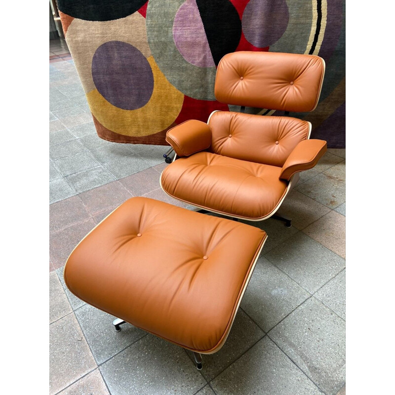 Vintage armchair and ottoman in cognac leather and rosewood by Charles Eames for Herman Miller, 2011