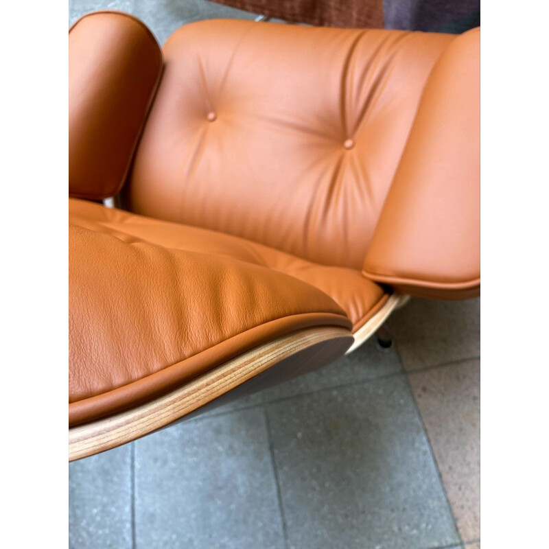 Vintage armchair and ottoman in cognac leather and rosewood by Charles Eames for Herman Miller, 2011