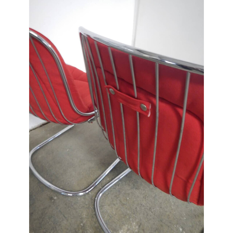 Pair of vintage rima armchairs in chromed metal and red fabric, Italy