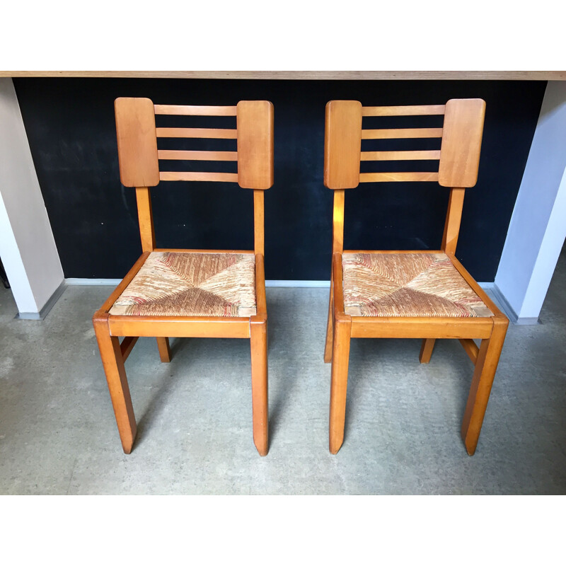 Pair of vintage wood and straw chairs by Pierre Cruège