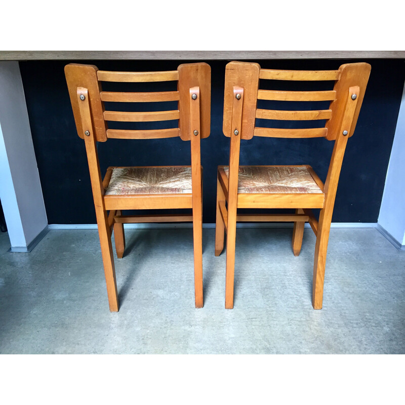 Pair of vintage wood and straw chairs by Pierre Cruège