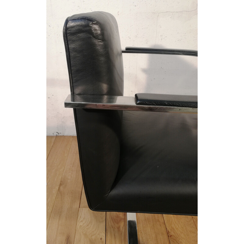 Vintage armchair in chrome steel and black leather