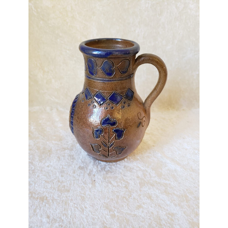 Vintage pitcher vase decorated with coats of arms and card game colors