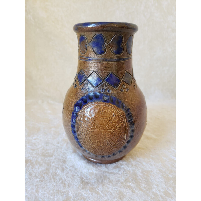 Vintage pitcher vase decorated with coats of arms and card game colors