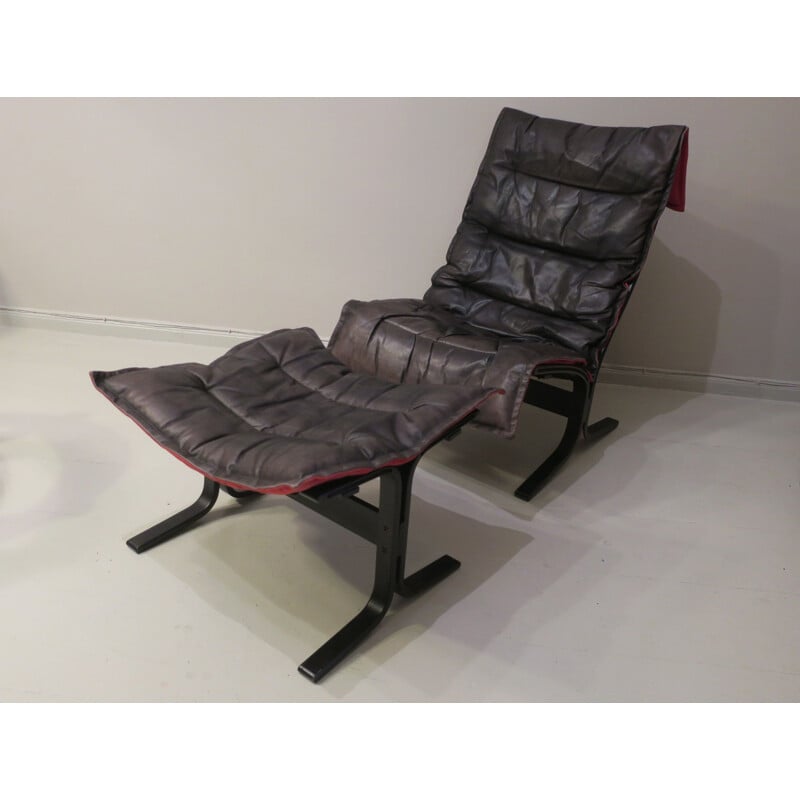 Vintage Siesta fauteuil en voetenbank in zwart leer met rode rug door Ingmar Relling