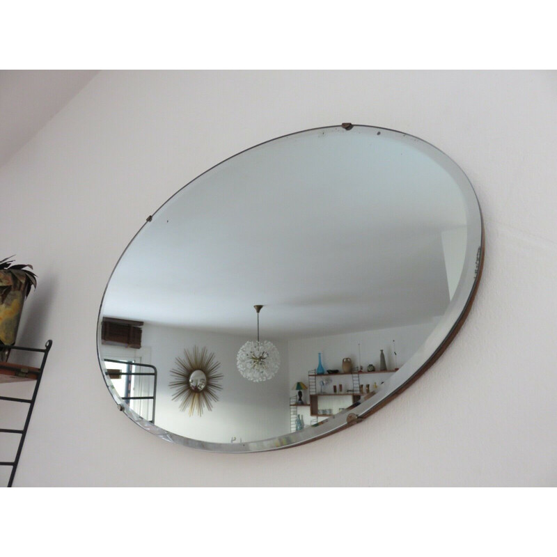 Vintage oval wall mirror with chain on wood, 1930