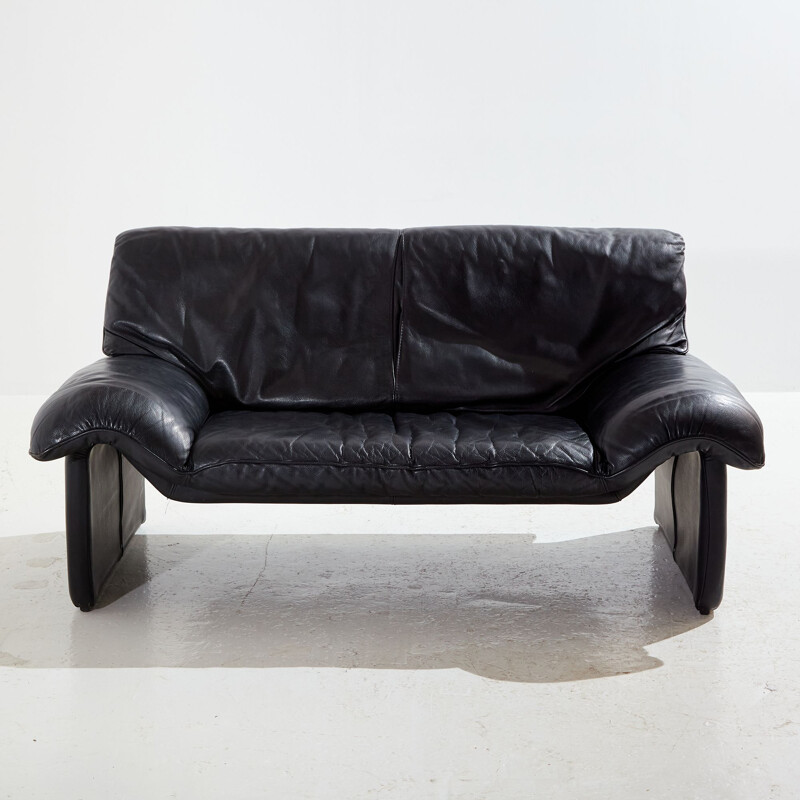 Vintage two-seater black leather sofa