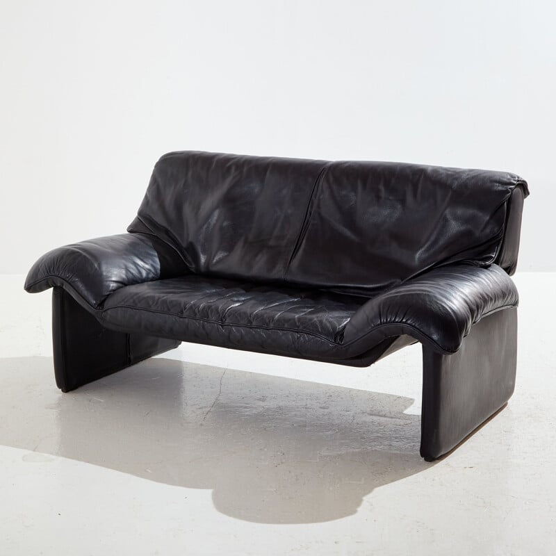 Vintage two-seater black leather sofa