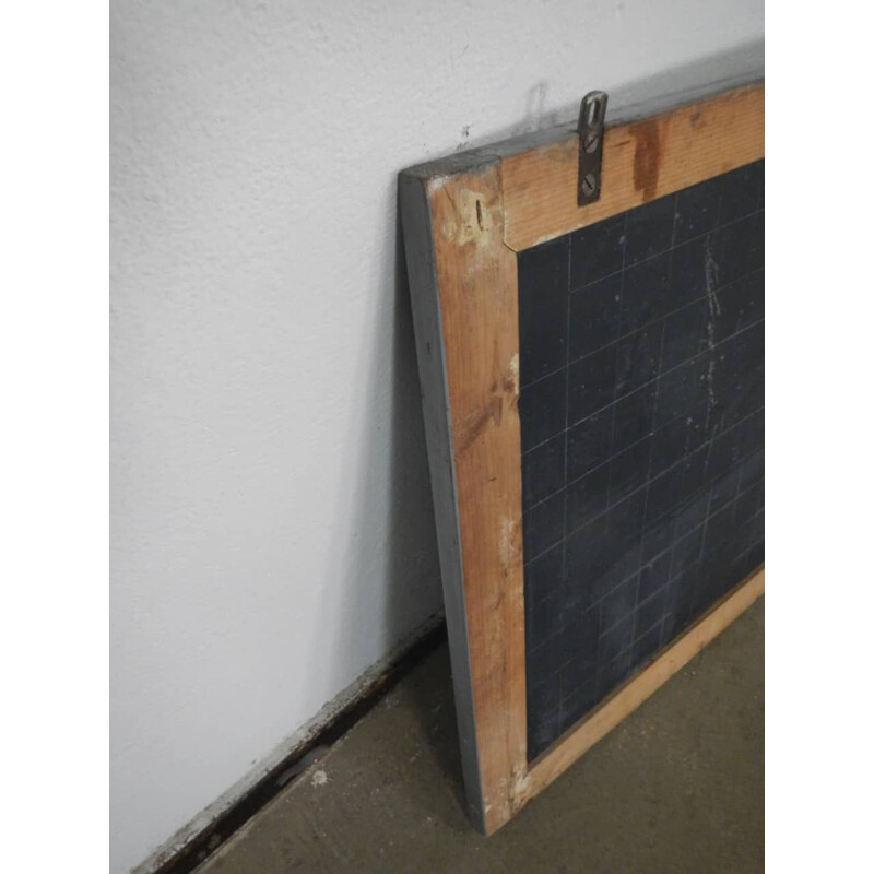 Grey vintage blackboard with chalkolder shelf