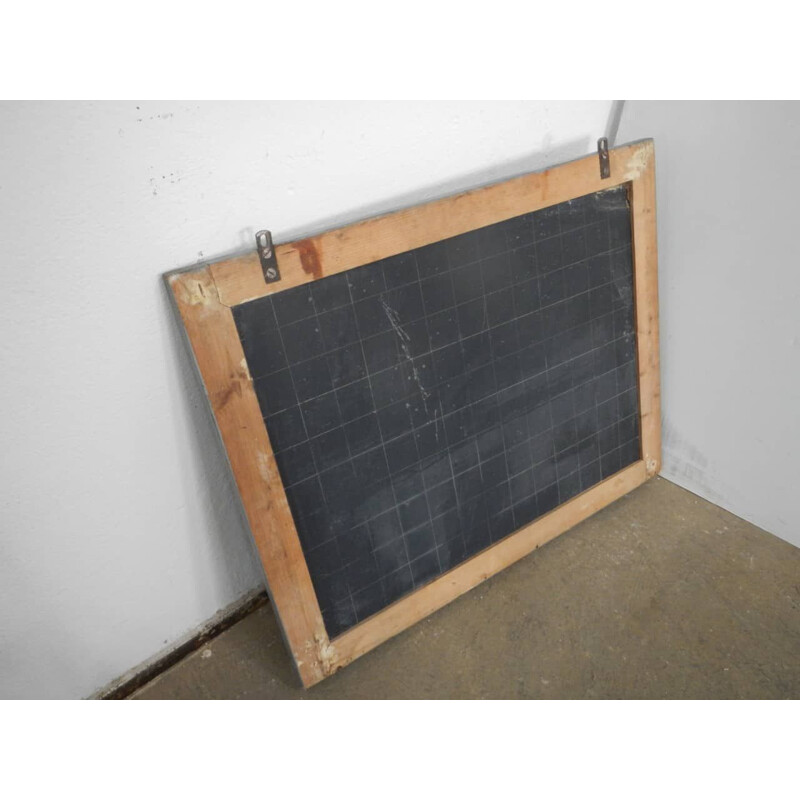 Grey vintage blackboard with chalkolder shelf