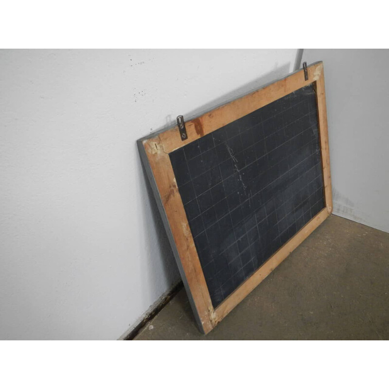 Grey vintage blackboard with chalkolder shelf