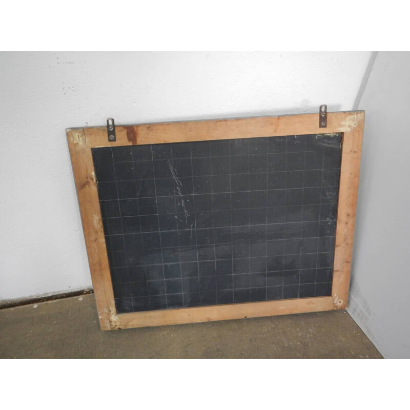 Grey vintage blackboard with chalkolder shelf