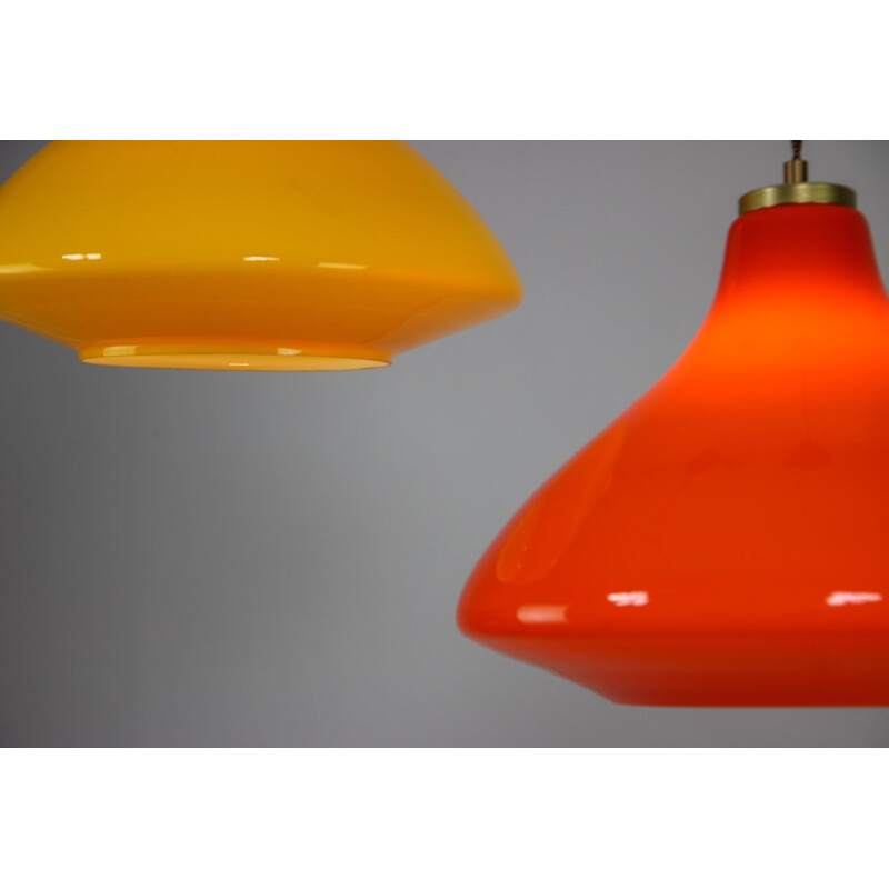 Pair of mid century yellow and orange glass pendant lamps