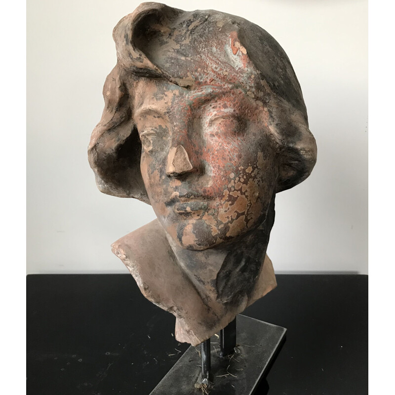 Vintage sculpture of a woman's head in terracotta