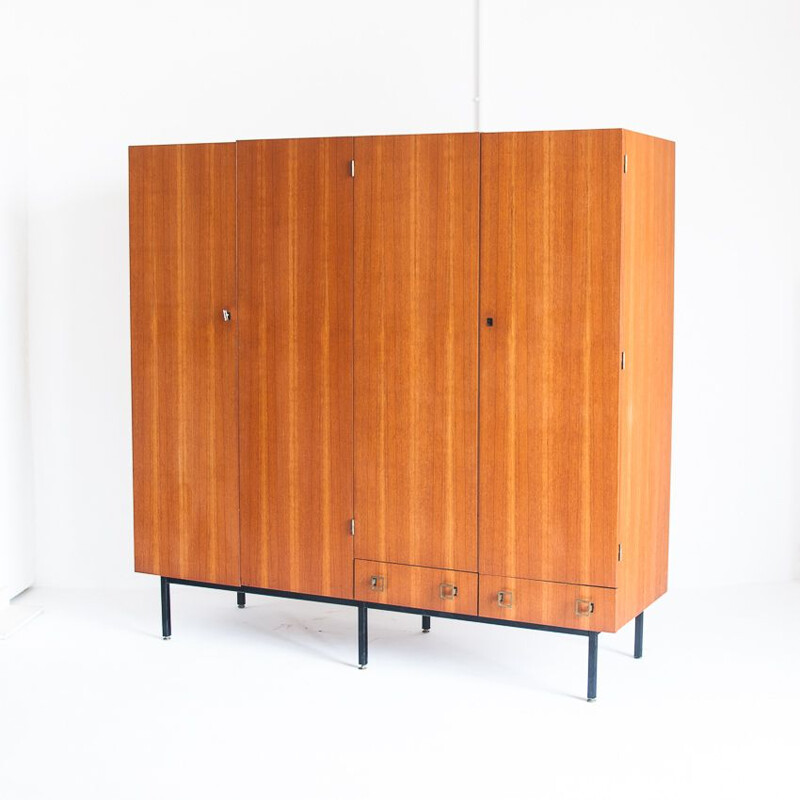 Vintage four door cabinet in teak with adjustable iron legs, France 1960