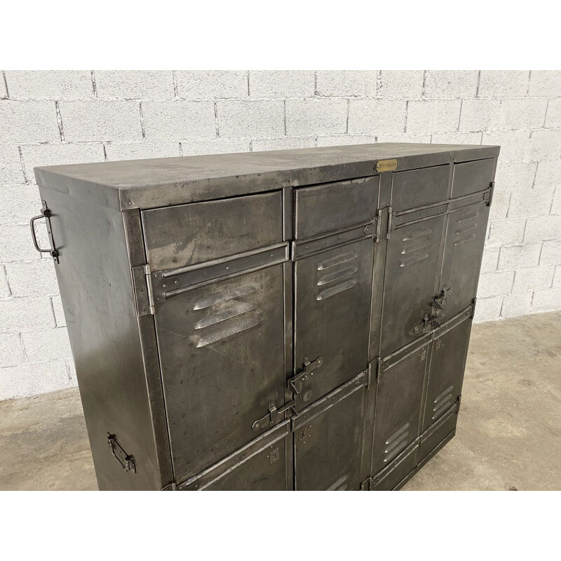 Vintage riveted metal travel locker on wheels, 1920