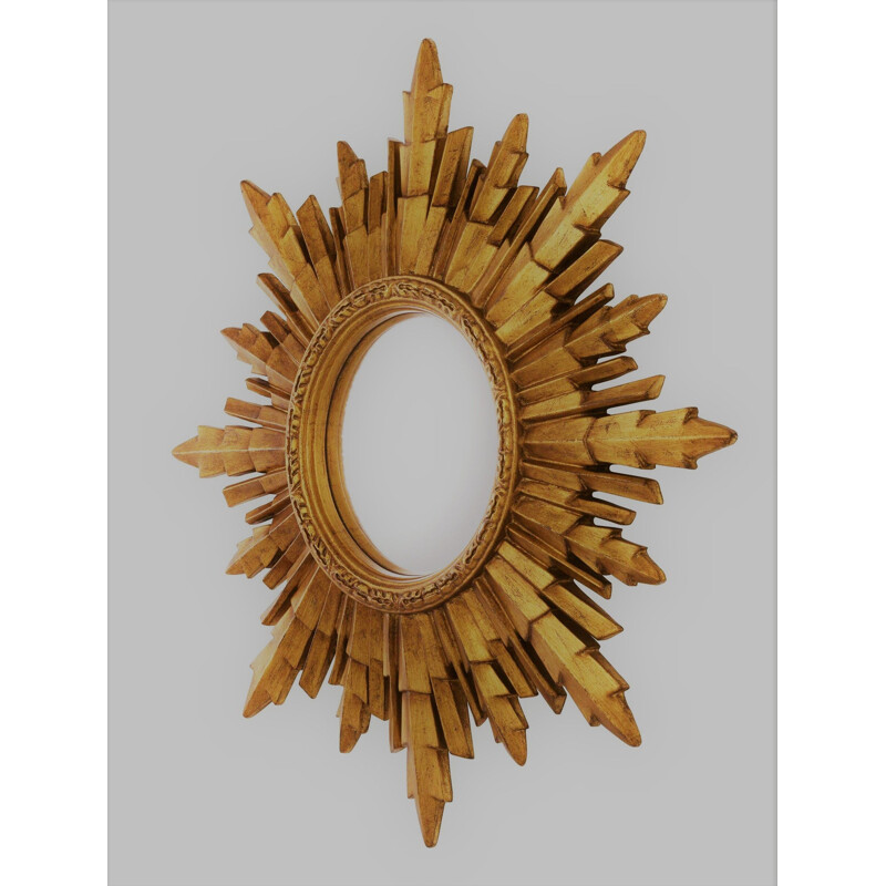 Vintage golden witch's eye mirror in sun shape