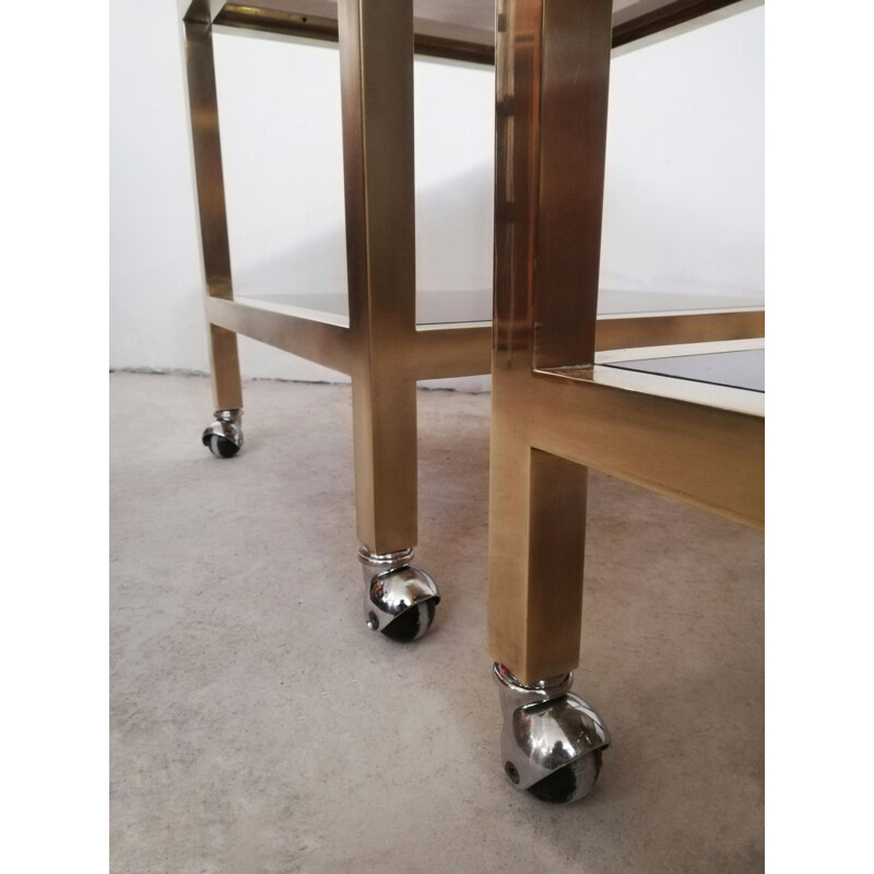 Pair of vintage brass and smoked glass side tables with casters, Italy 1970