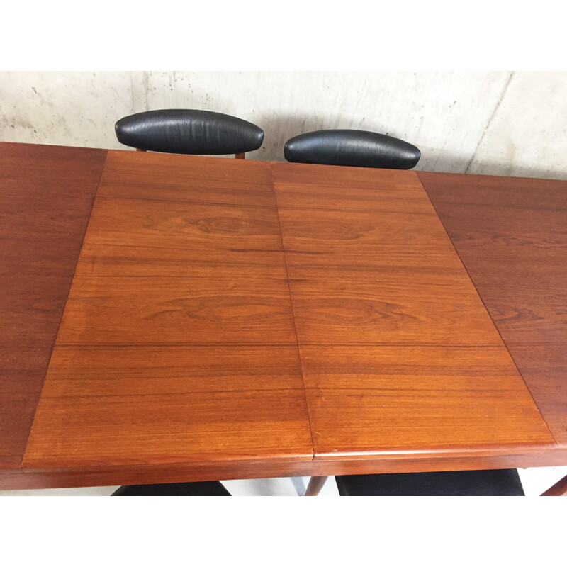 Set of extendable dining table and 6 chairs in teak and black leatherette - 1970s