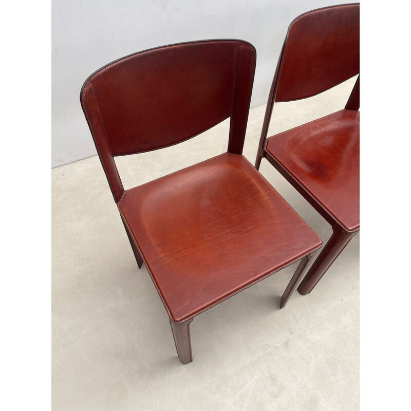 Set of 8 mid-century red leather dining chairs model "Sistina Saddle" by Tito Agnoli for Matteo Grassi, Italy 1980s