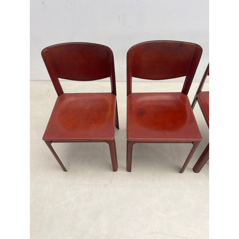Set of 8 mid-century red leather dining chairs model "Sistina Saddle" by Tito Agnoli for Matteo Grassi, Italy 1980s