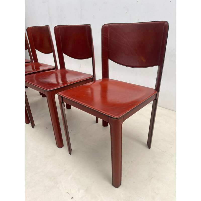 Set of 8 mid-century red leather dining chairs model "Sistina Saddle" by Tito Agnoli for Matteo Grassi, Italy 1980s