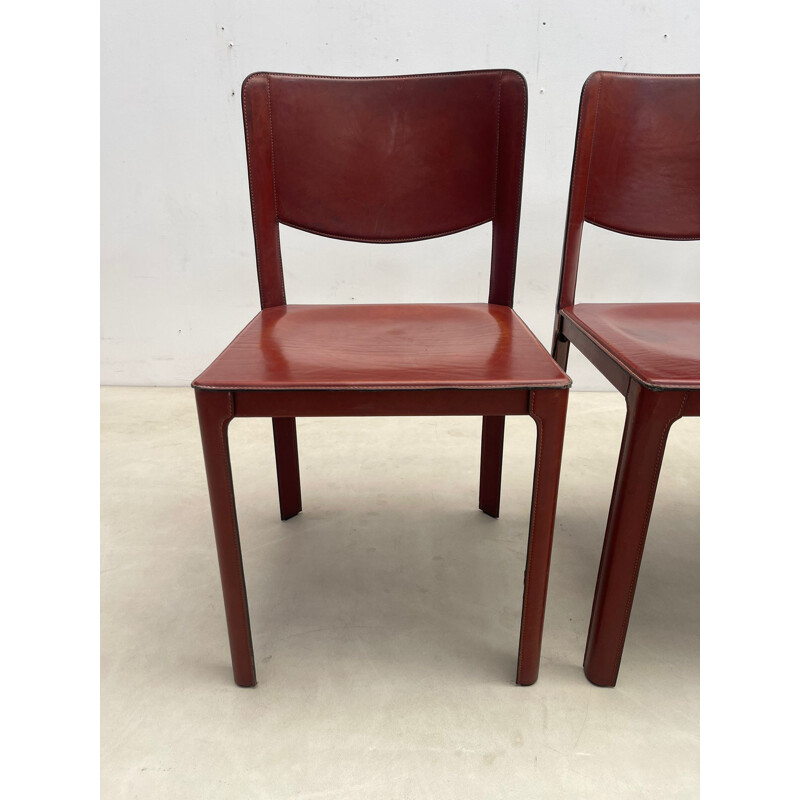 Set of 8 mid-century red leather dining chairs model "Sistina Saddle" by Tito Agnoli for Matteo Grassi, Italy 1980s