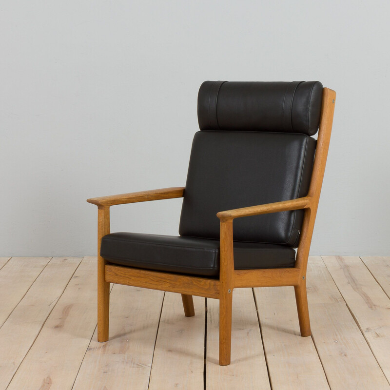 Vintage Ge 265 armchair in oakwood & black leather by Hans Wegner for Getama, Denmark 1970-1980s