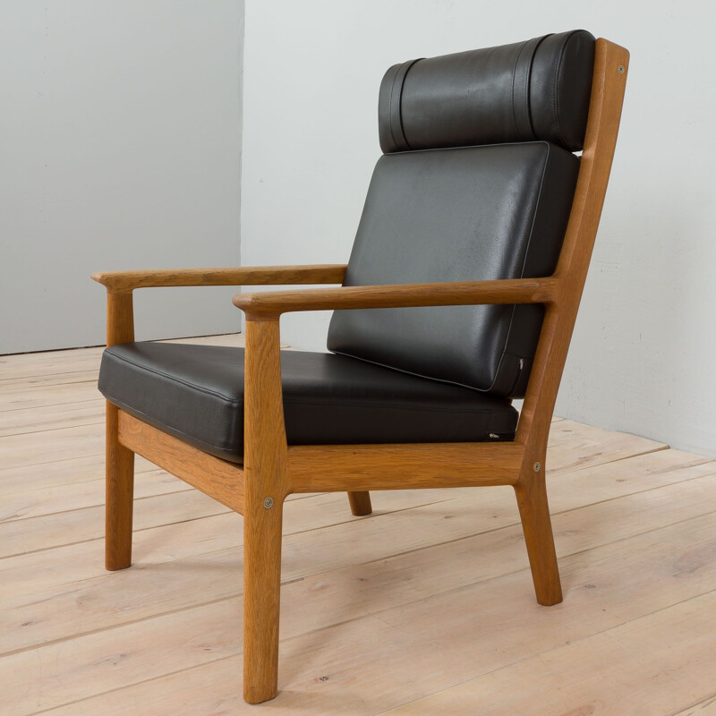 Vintage Ge 265 armchair in oakwood & black leather by Hans Wegner for Getama, Denmark 1970-1980s